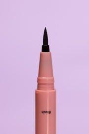 Close up of felt tip black adhesive eyeliner used to glue on fake eyelashes.